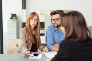 Young couple meeting with insurance agent